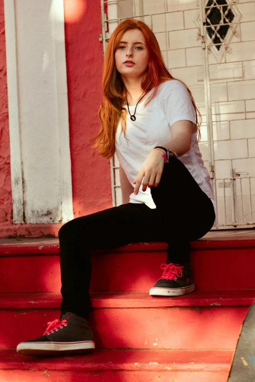 the young woman is sitting on the step