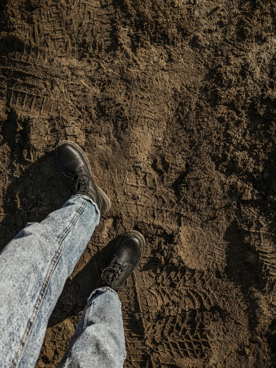 someone's feet on the ground looking down