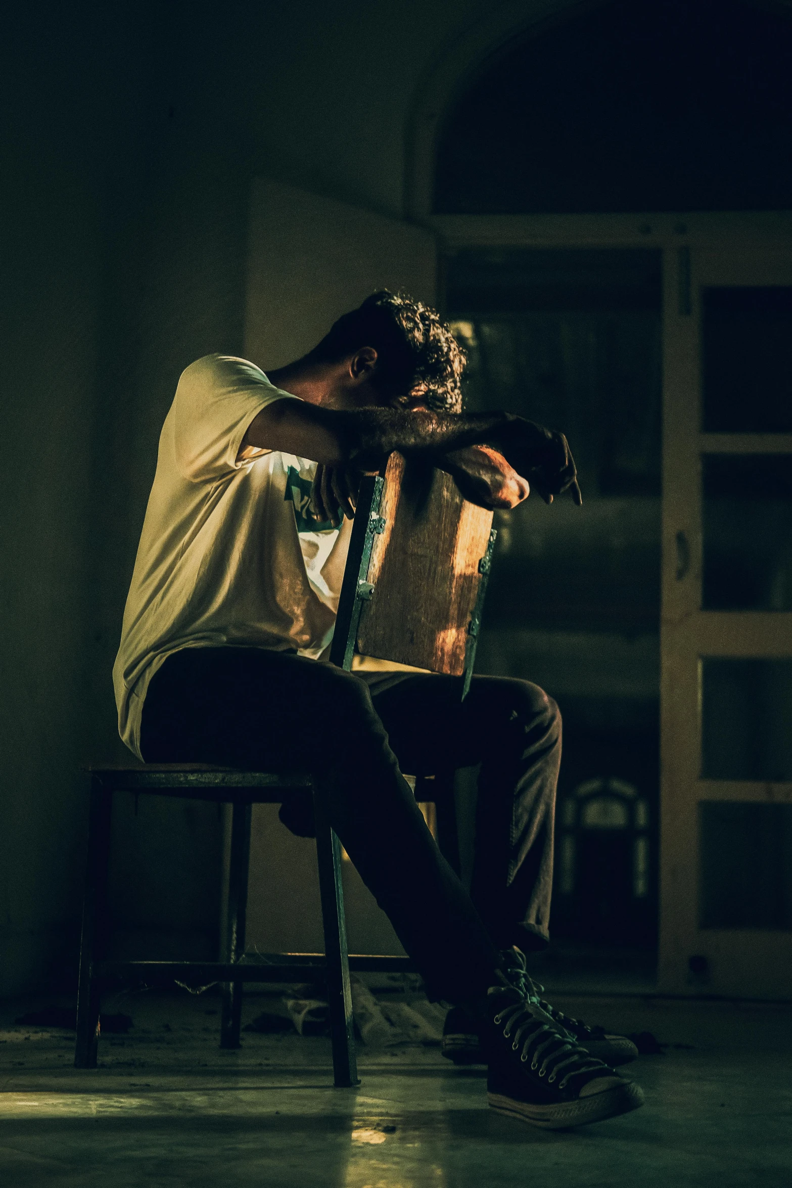 a person sitting in a chair and looking at soing on their phone