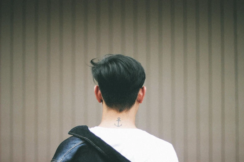 back view of man in white shirt and black leather jacket