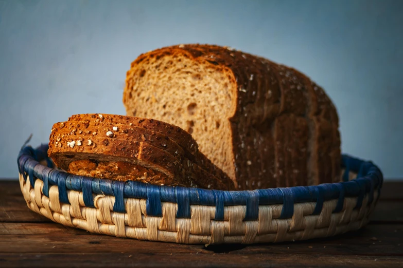 loaf of bread in a blue basket on a table