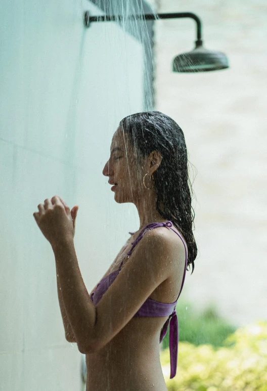 a woman that is standing in the rain