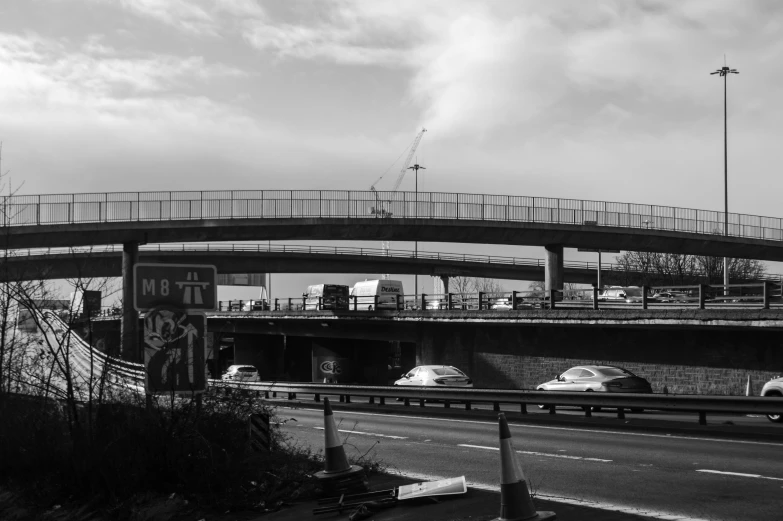 black and white pograph of a highway with cars traveling