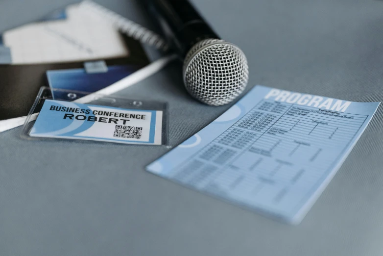 a microphone, sticker and name label on a desk