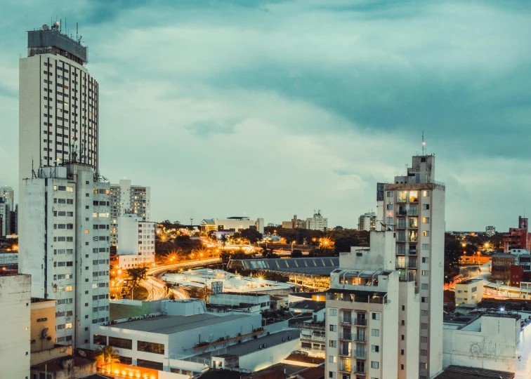 a view of a city skyline at dusk from a high rise building