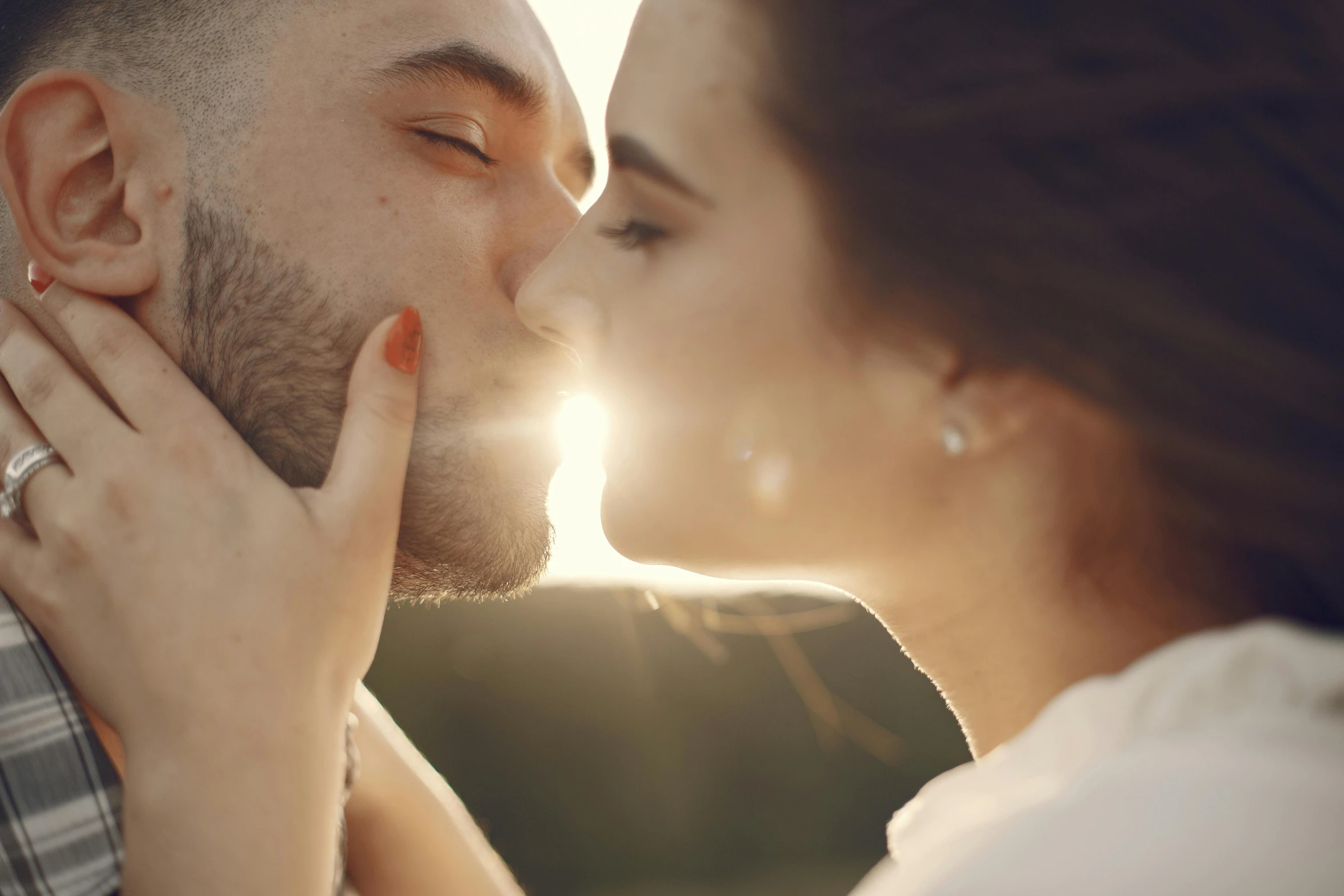 a woman and a man share a kiss