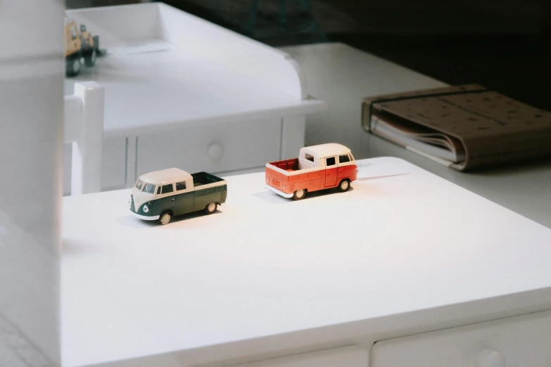 two toy cars are sitting on a counter