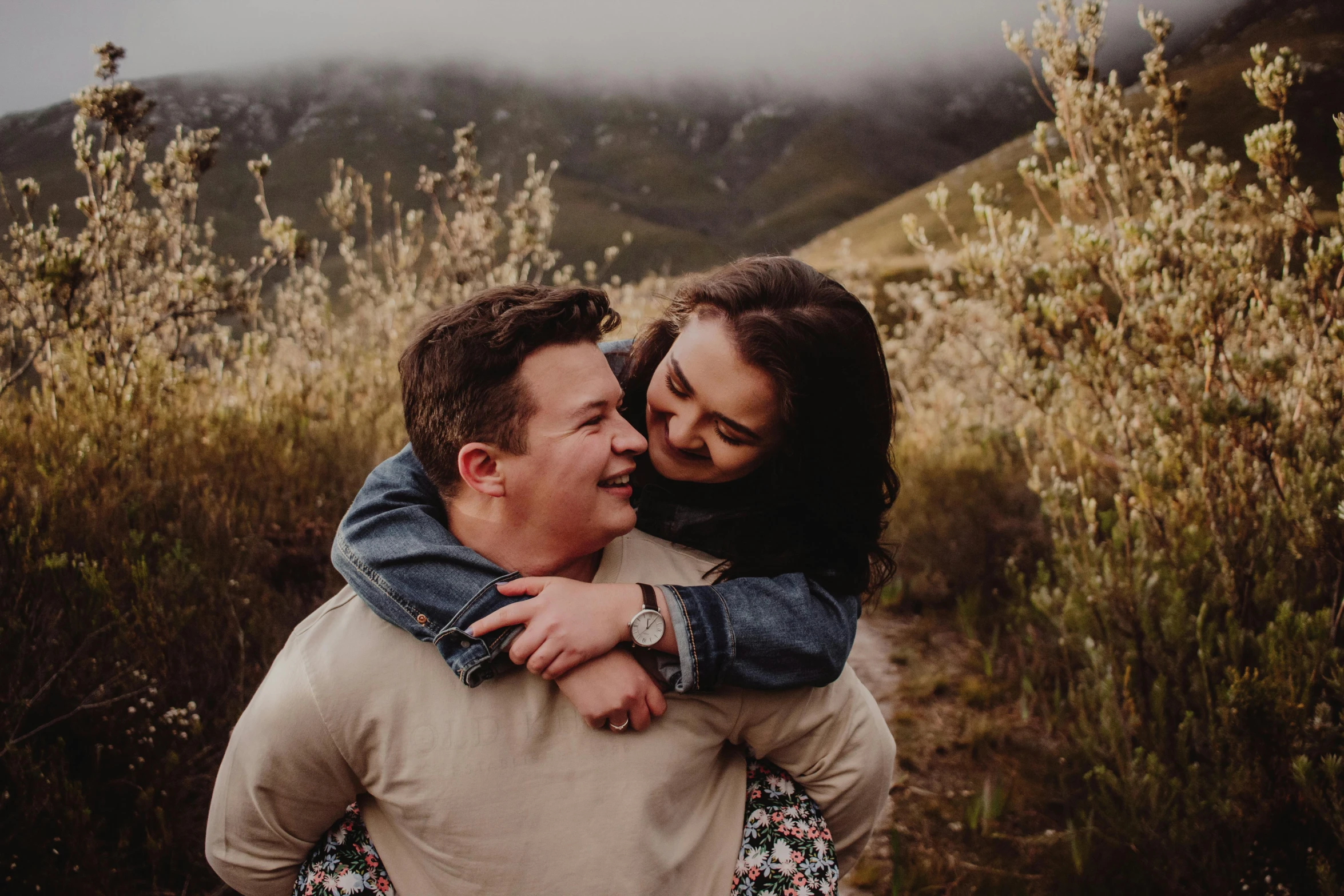 a man hugging a women on the head while they walk