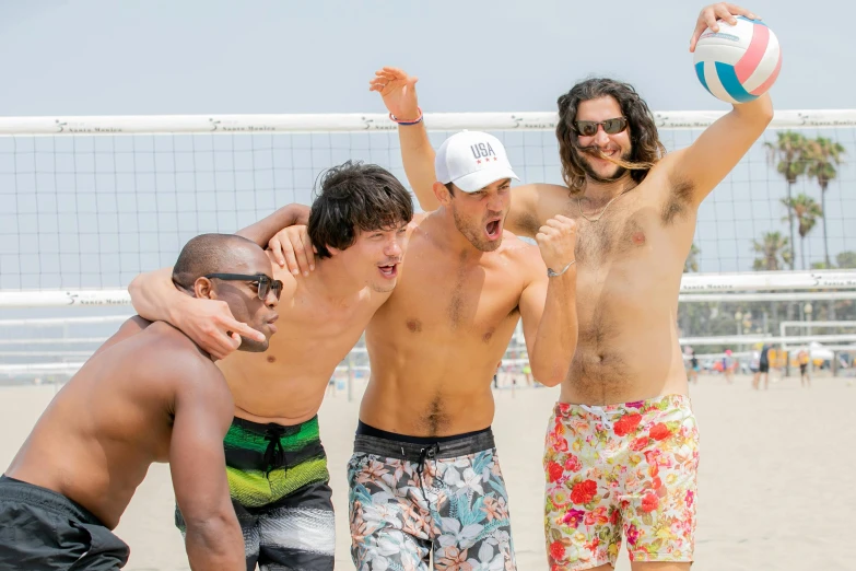 men on a beach playing volleyball on the sand