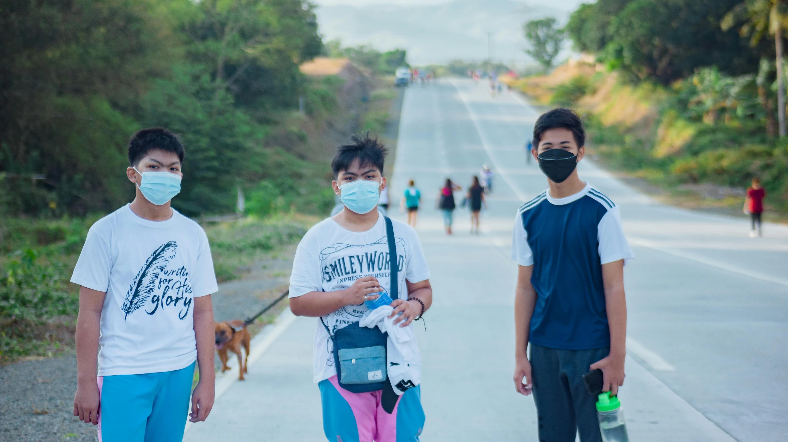 three people with masks on standing next to each other