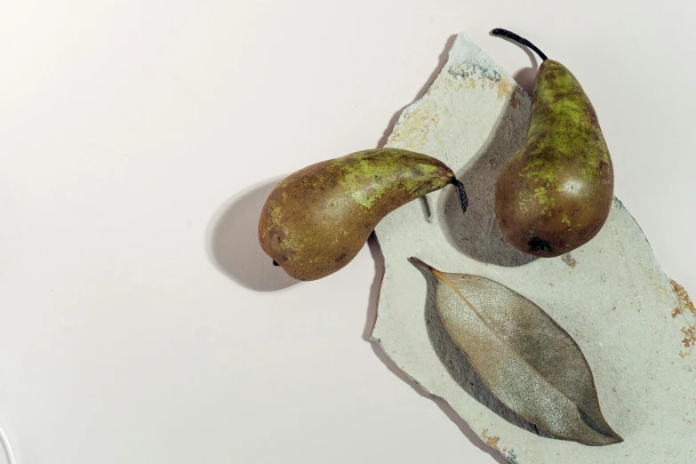 three pears are sitting on a  board