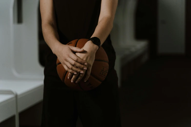 a person holding a basketball and wearing glasses