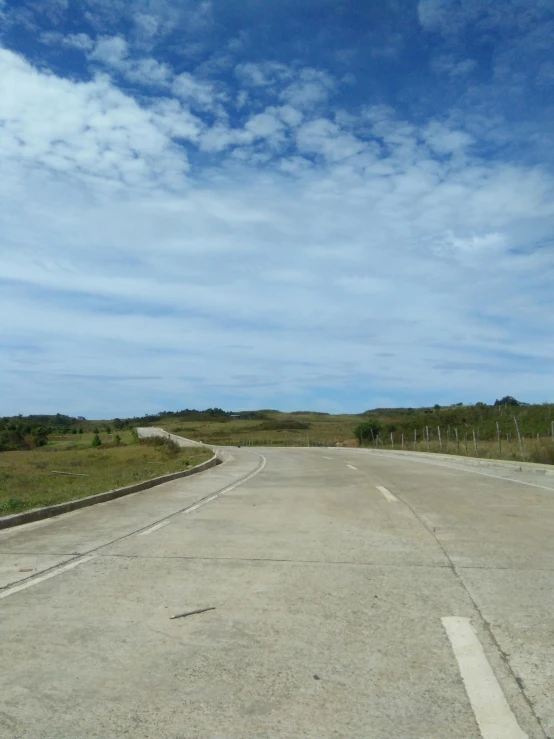 the empty road is very quiet and has little traffic