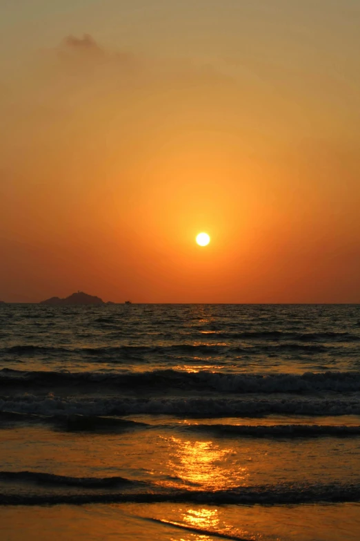 sunsets over the ocean at sunset with waves and sun reflecting off the surface