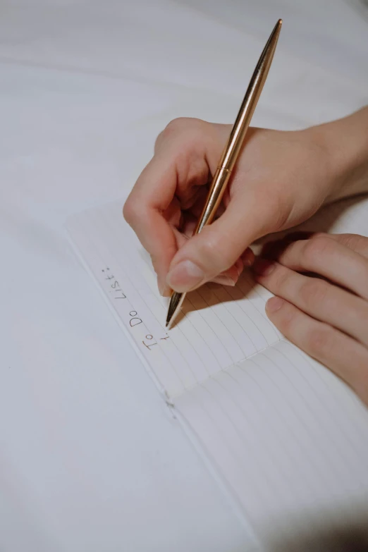 person doing research on a lined paper with a pen