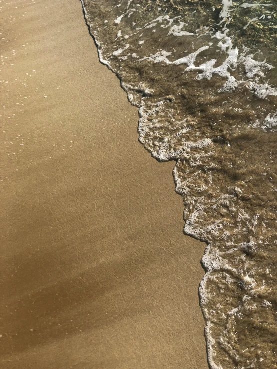 an ocean beach with a surfboard in the water