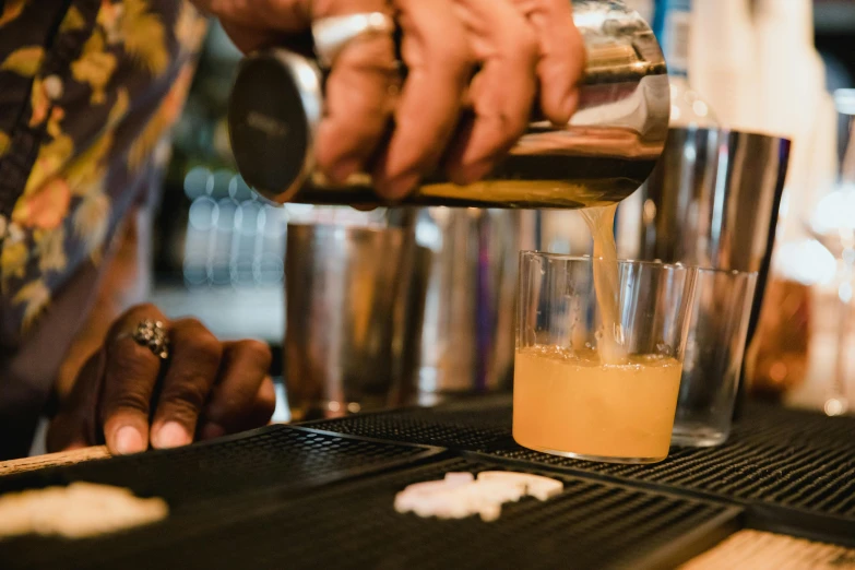 bartender filling up a cup with orange juice