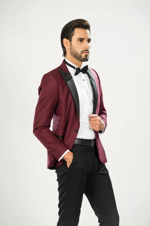 a man in a maroon tuxedo with a bow tie