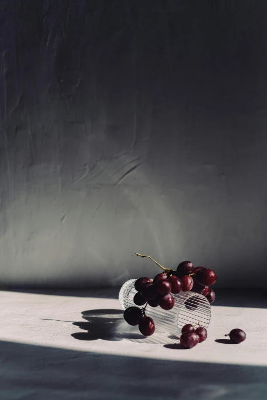 a basket filled with cherries on top of a table