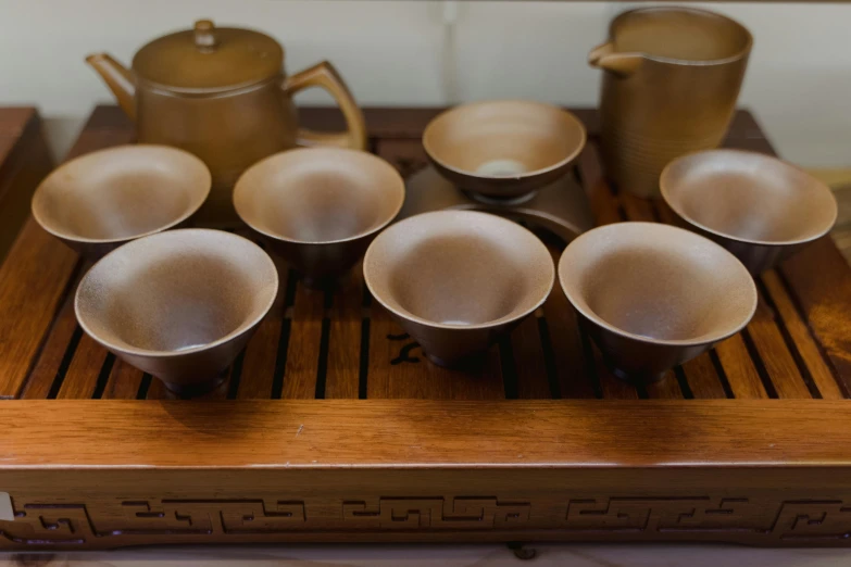 a display with an asian tea set and coffee cup