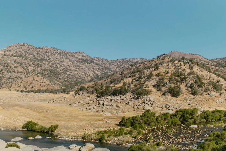 the river is running through a hilly area