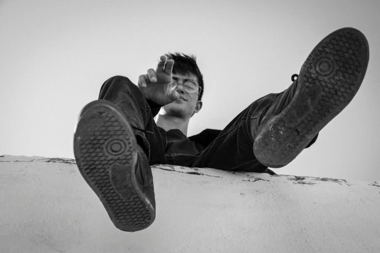 black and white po of a man leaning on a ledge