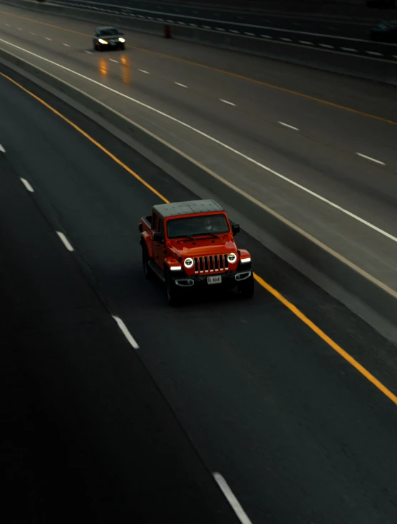 an automobile drives down the street in the evening