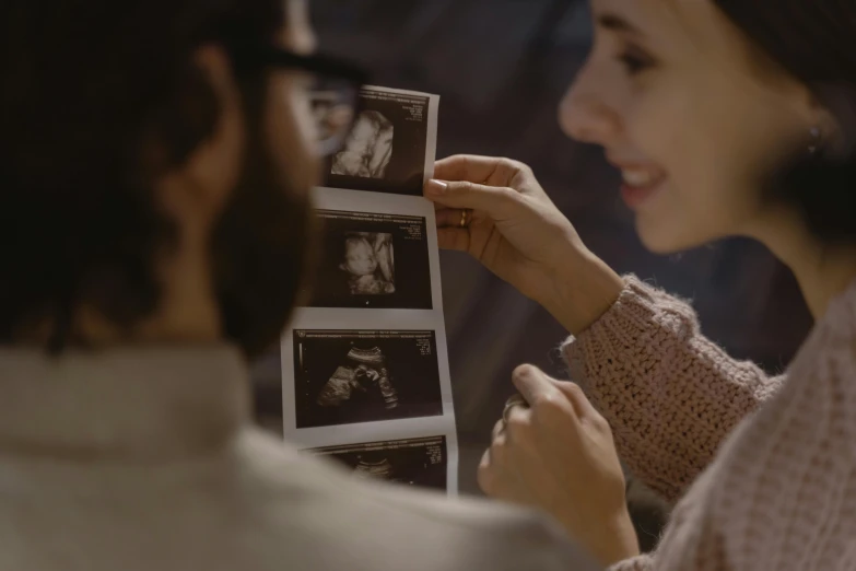 two women looking at some pictures and smiling