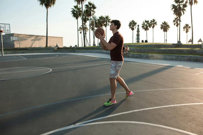 a man that is standing on a basketball court with a ball