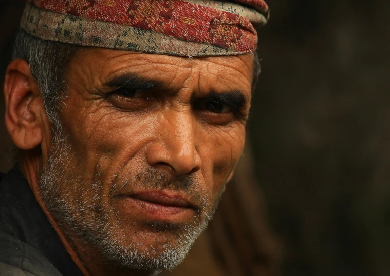 a man in a red hat has a gray beard