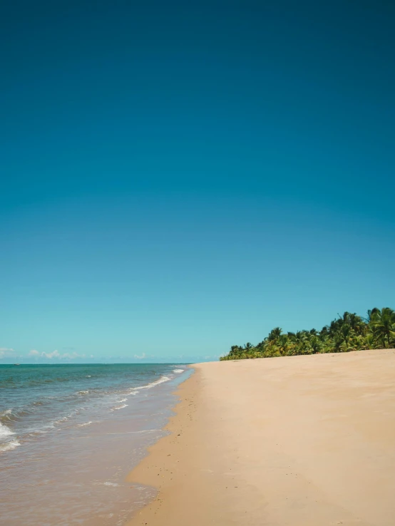 a picture of the ocean with a boat that is out on the shore