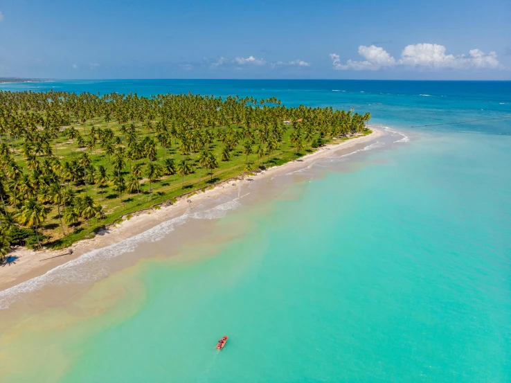 an island sits next to the ocean and beach