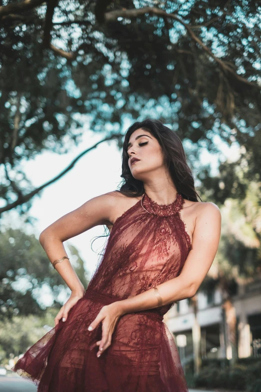 a woman standing on the side of a street