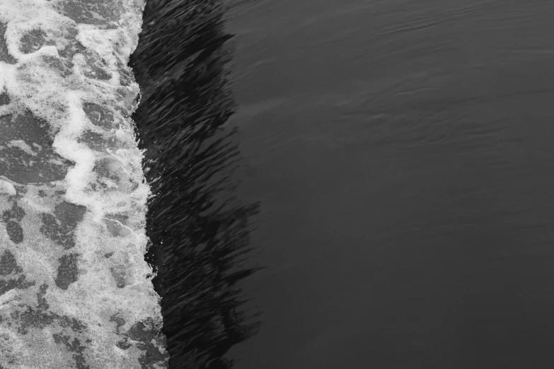 a large wave coming towards shore from above