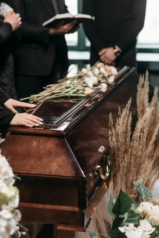 a close - up of a casket with a person standing behind it