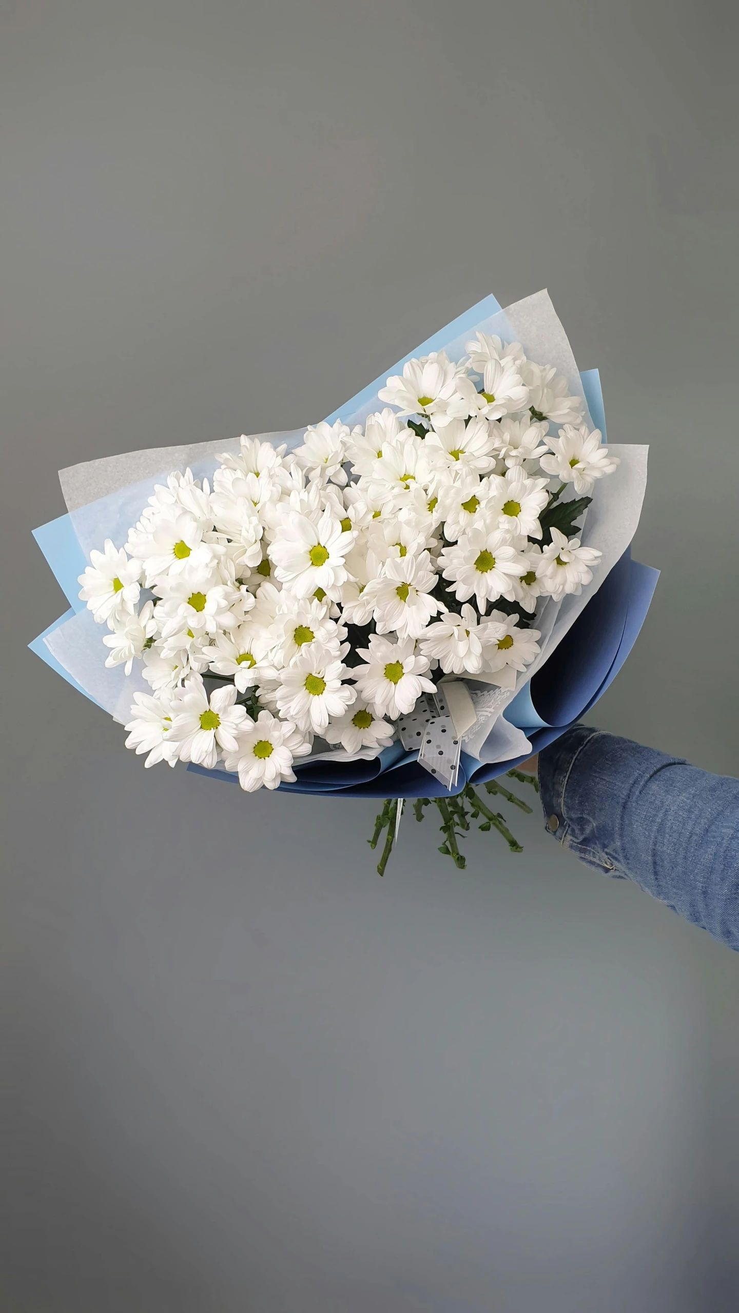 white flowers tied to a light blue paper