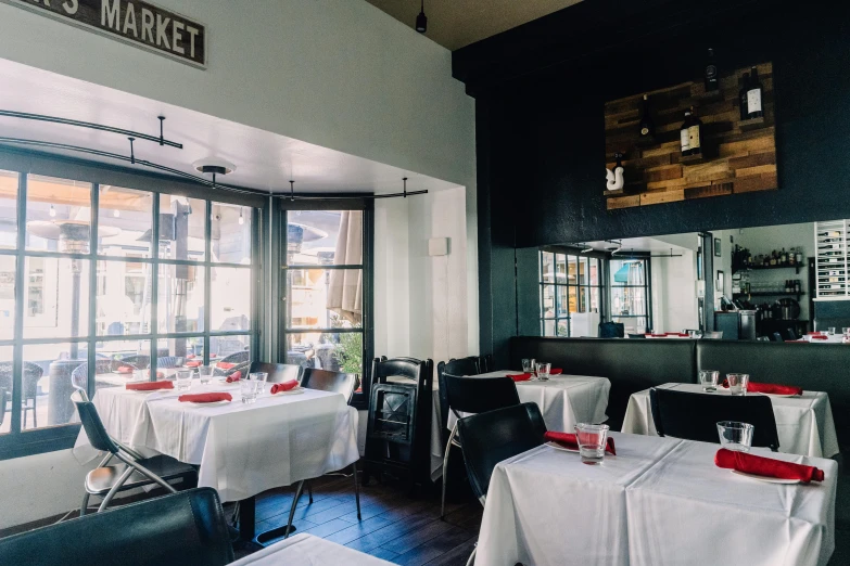 empty tables at a restaurant are set for a meal