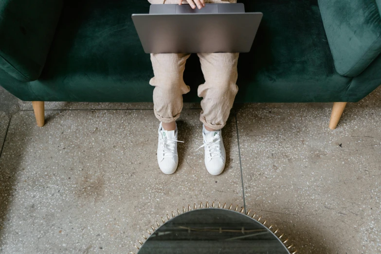 a man sits with his foot propped on a table top