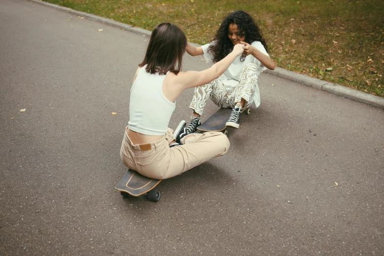 a young woman sitting on top of a skateboard