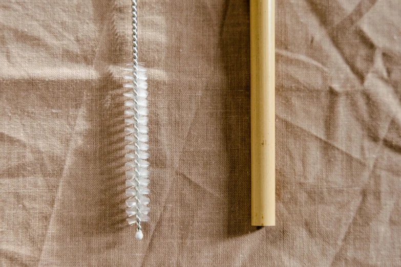 a pencil laying next to some string on a table