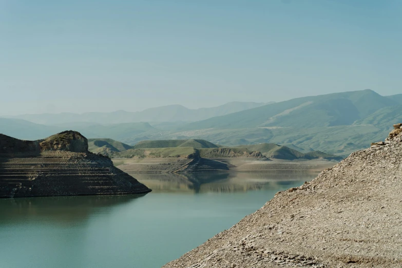 a large mountain with two large cliffs and one huge lake