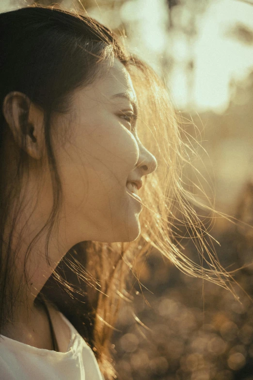 a woman has her hair blown in the wind