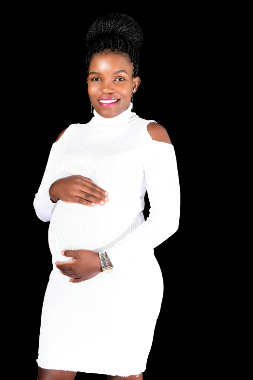 pregnant woman in white dress smiling while standing with hands on stomach