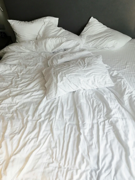 bed with white comforter and plain comforter