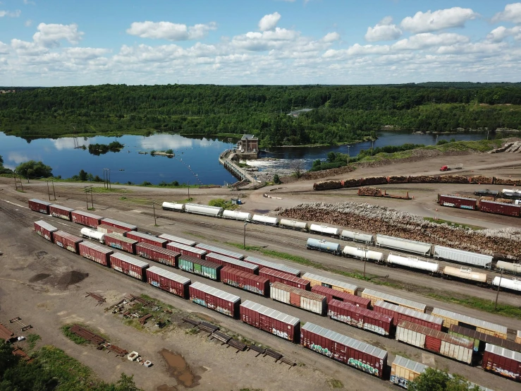 long cargo train crossing open train area in rural area