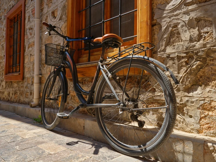 a bike parked next to a stone building