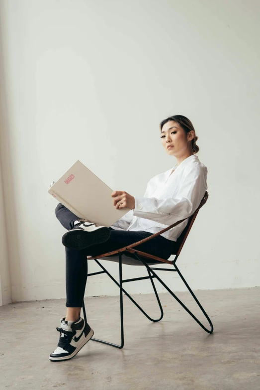 woman sitting in chair with a laptop on her lap