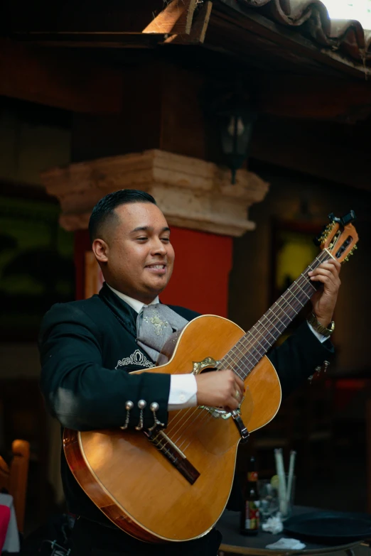 a man is holding onto an acoustic guitar