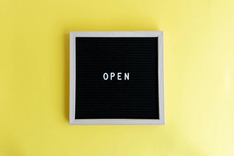 the word open written on an empty black letter board