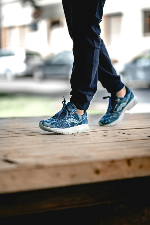 a man with a walking shoe on a wooden platform